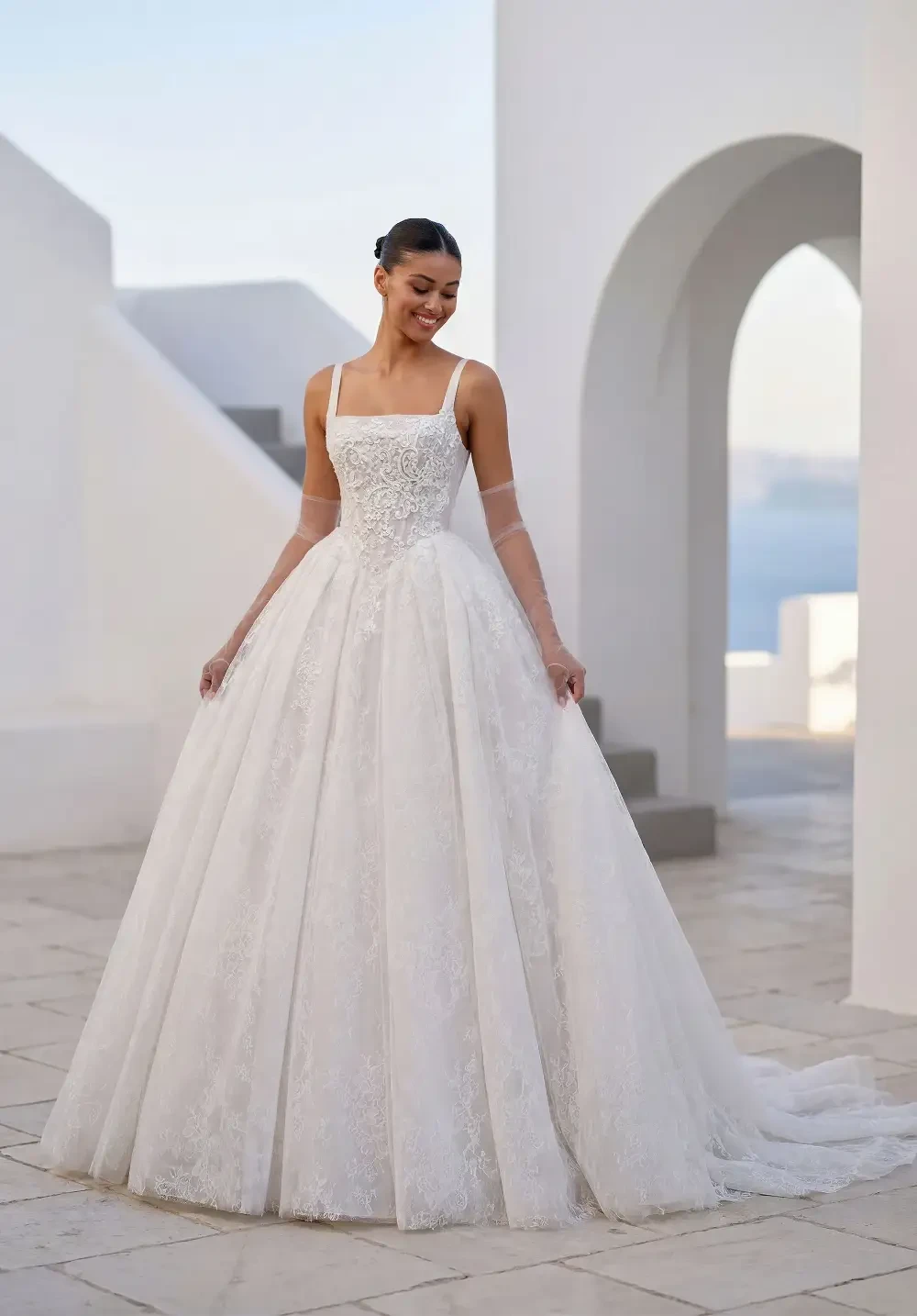 model is wearing a sleeveless a-line bridal gown