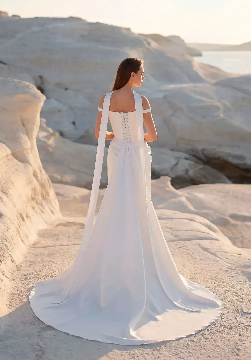 model is wearing a sleek bridal gown with a scarf