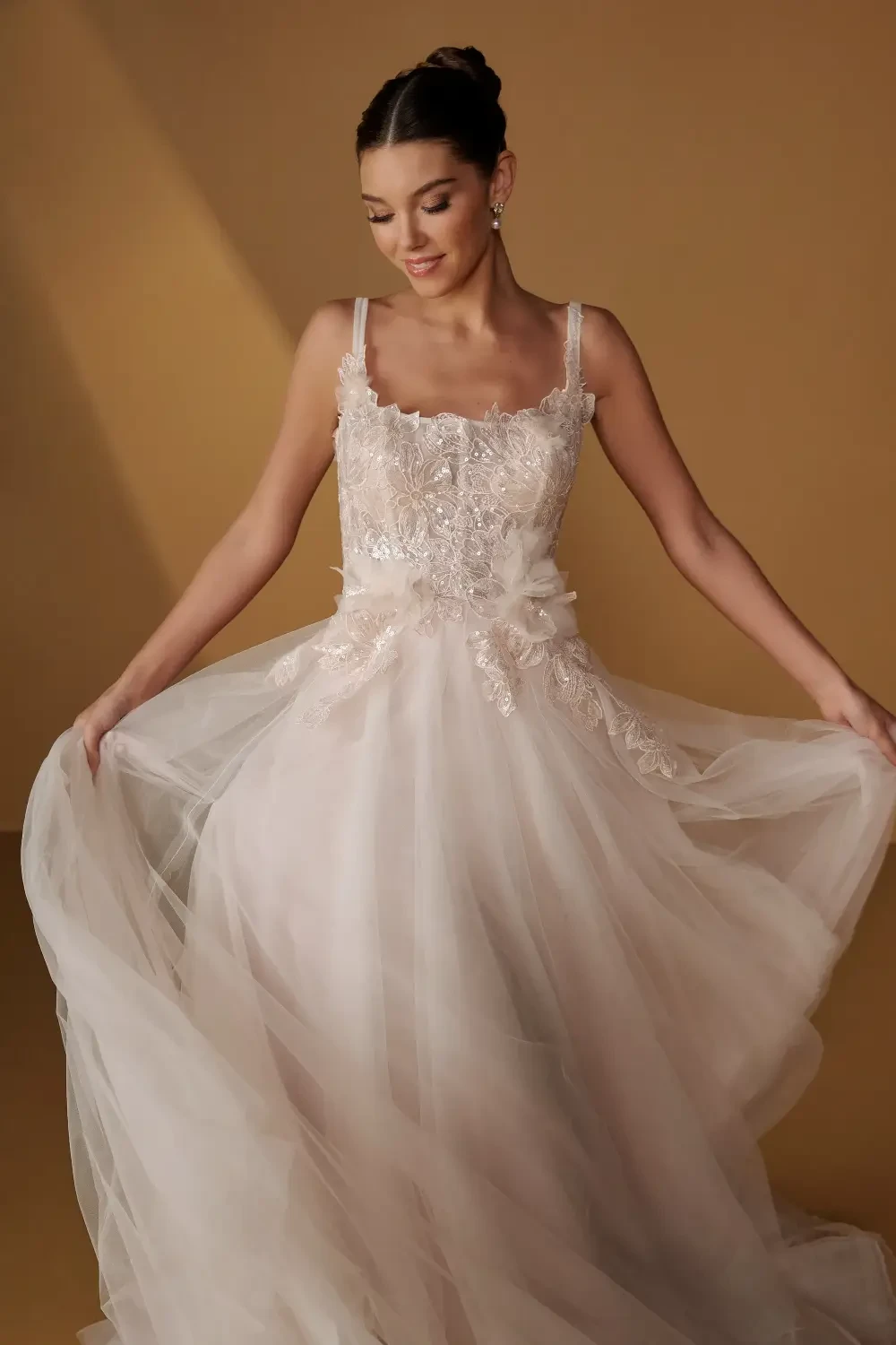 model is wearing a sleeveless square neckline a-line bridal gown