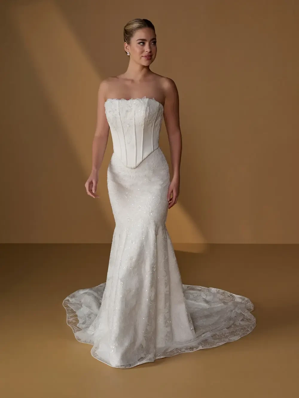 model is wearing a fitted strapless bridal gown
