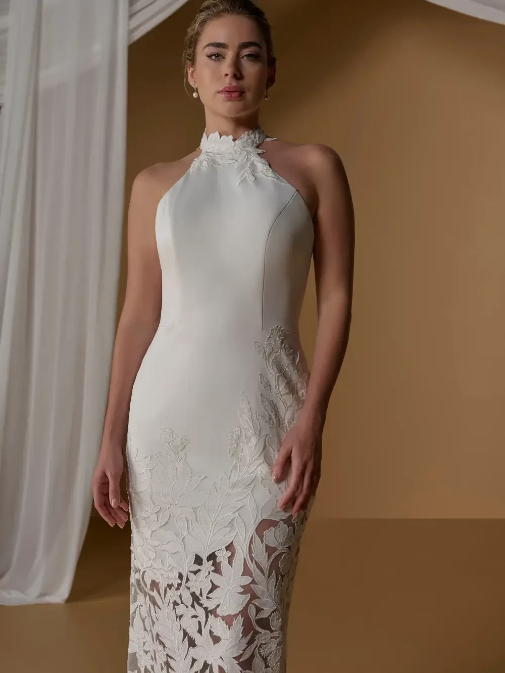 model is wearing a high neckline sleeveless wedding dress