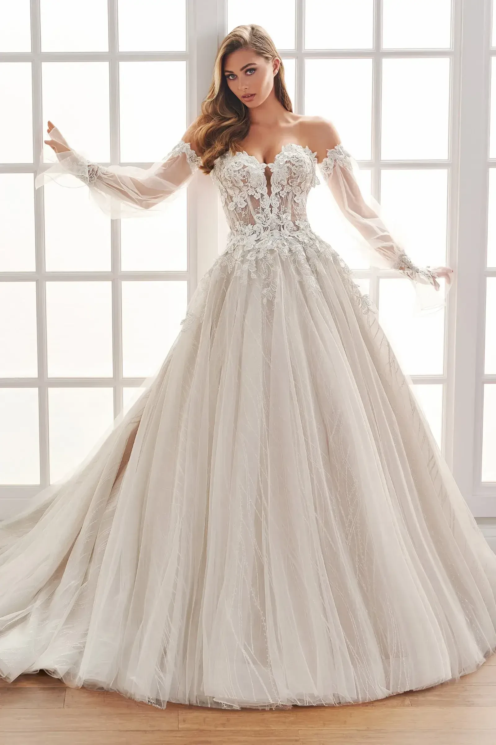model is wearing a strapless ball gown with detachable sleeves